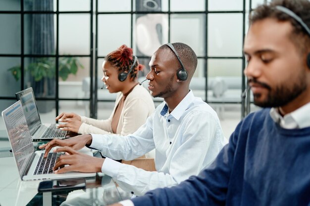 Call center operator in headset working in office