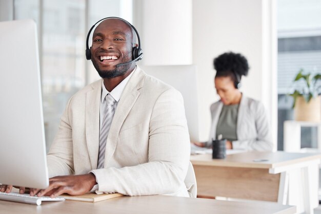 Photo call center portrait and black man consulting for crm telemarketing and customer service with a smile happy face and male consultant in office for online help support and faq or contact us