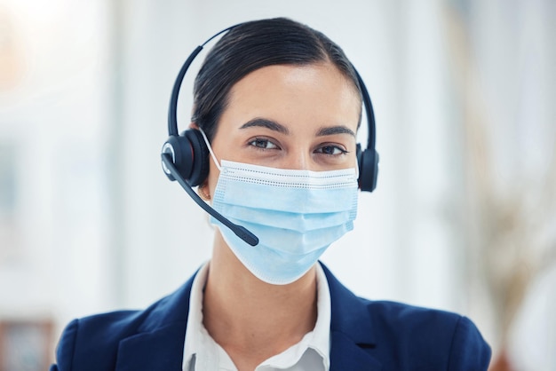 Call center support or covid help worker with mask for safety and corona protection at work CRM business telemarketing or customer service consultant consulting on covid 19 contact us question