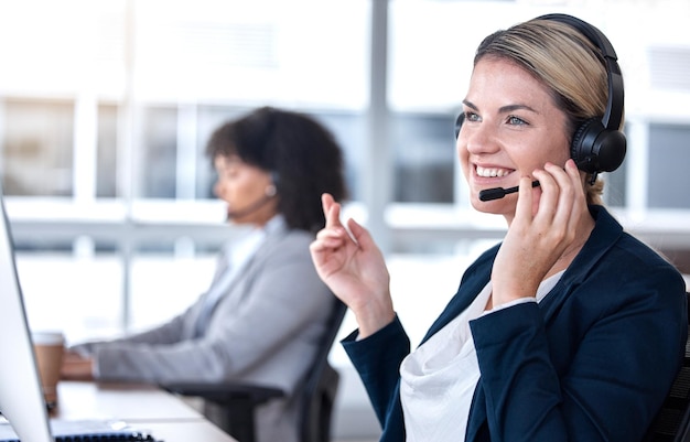 Photo call center talking and happy woman in office for communication support and contact us for customer service smile telemarketing and sales agent consultant or employee listening to conversation