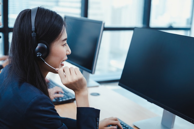 Photo call center woman advising customers calling.
