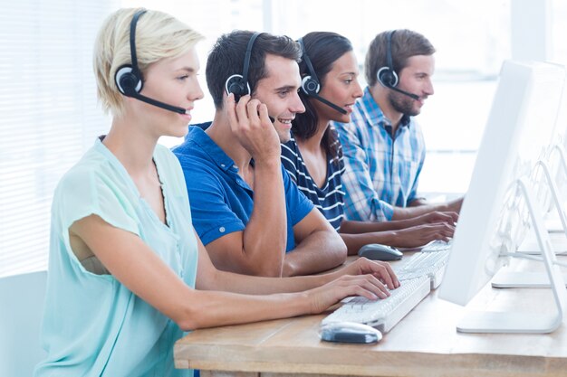 Call centre workers on their laptops