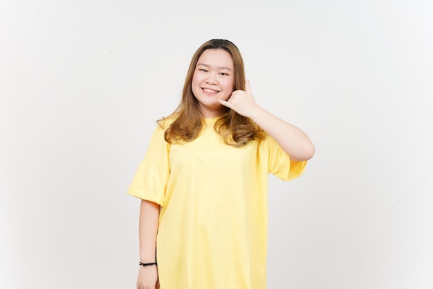 Call me back gesture of Beautiful Asian Woman wearing yellow TShirt Isolated On White Background