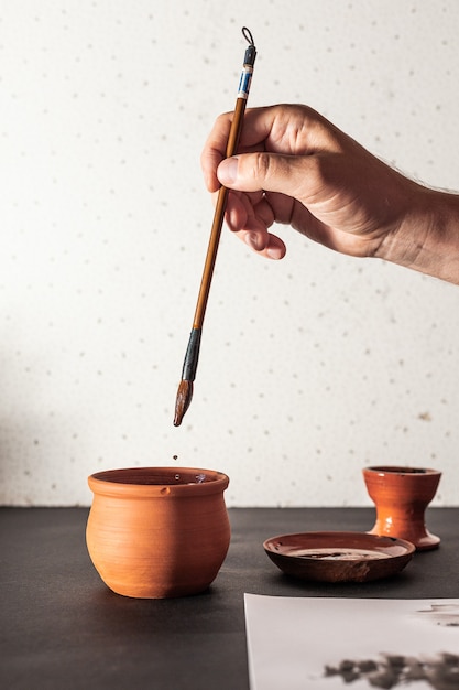 Calligraphy master work table with paper and pen