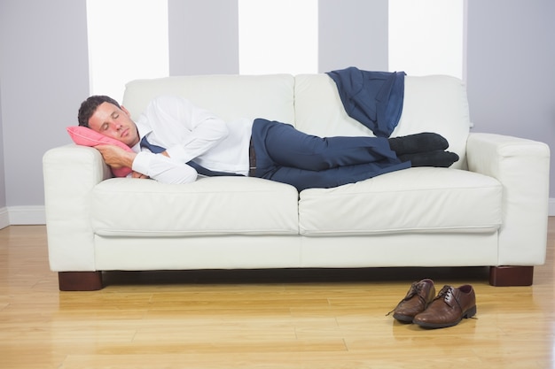 Calm attractive businessman lying on couch