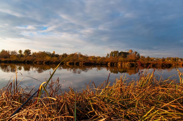 calm on an autumn lake with orange shores