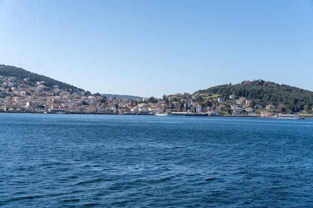 A calm blue ocean with a city in the background