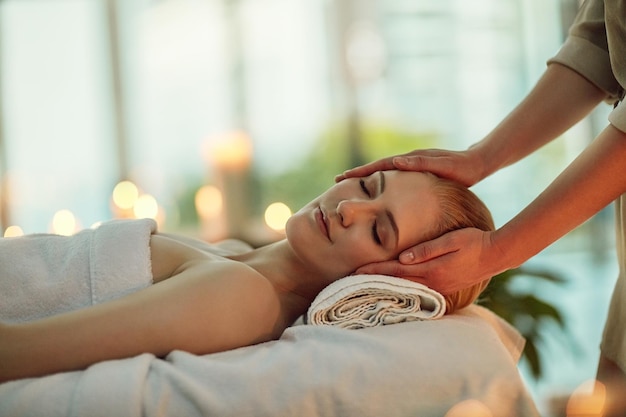 Calm the body clear the mind Cropped shot of a young woman enjoying a head massage at a spa