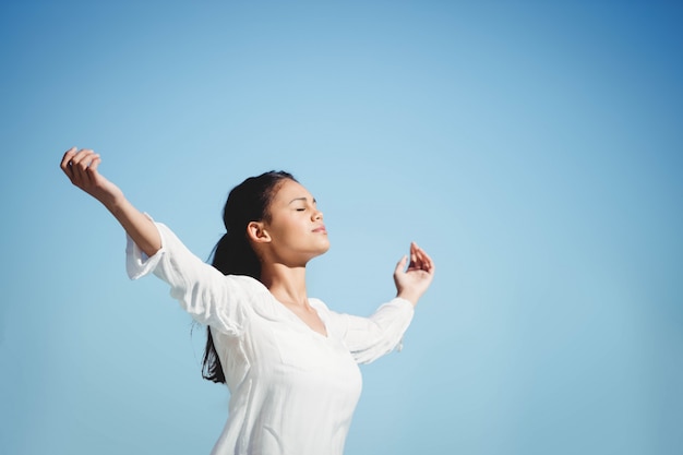 Calm brunette doing yoga in a sunny day