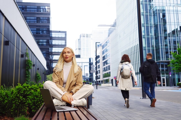 Calm business woman meditating in lotus outdoors