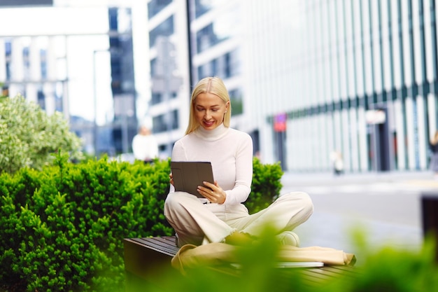 Calm business woman meditating in lotus outdoors