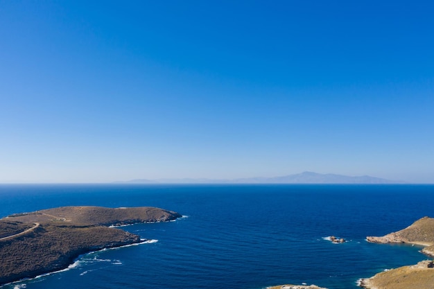 Calm clear water blue sky background aerial drone view