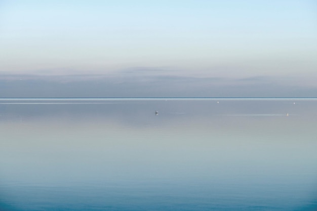 Calm cool and relaxing front view of the ocean horizon copy space on top Mist over the sea on a new morning Clear and blue sky during a tranquil dusk evening with natural background