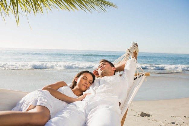 Calm couple napping in a hammock