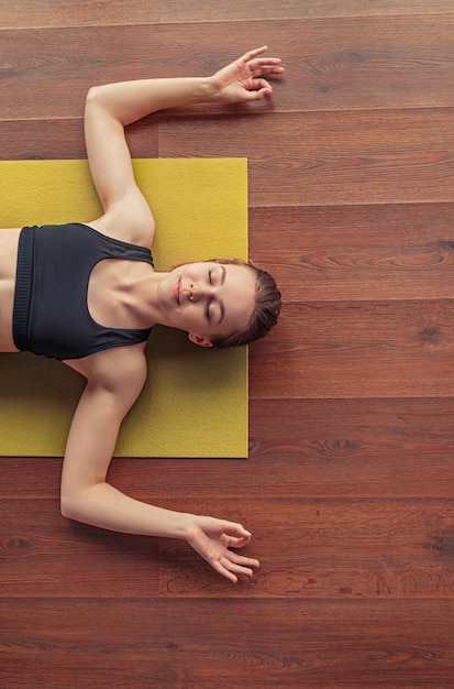 Calm female practicing yoga and showing om gesture