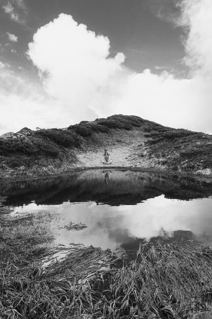 Calm lake with hilly bank monochrome landscape photo