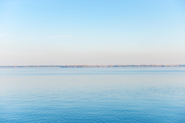 Calm landscape with sea water and a coast on horizon