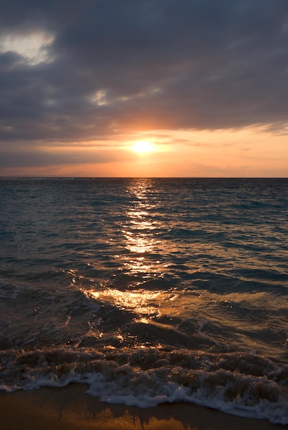 Calm ocean and beach on tropical sunrise