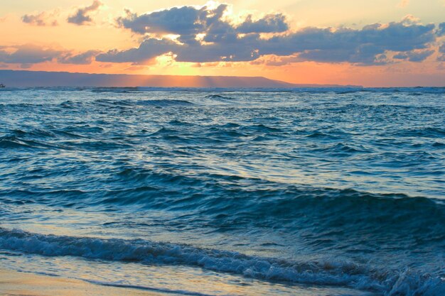 Calm ocean and beach on tropical sunrise