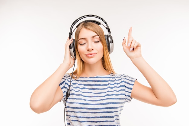 Calm relaxed young woman with headphones and closed eyes