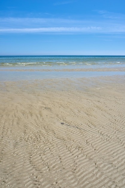 Calm sea Beautiful landscape of the beach with a blue sky and copy space on a summer day Peaceful and scenic view of the ocean shore or sand on a sunny afternoon The calm sea outdoors in nature