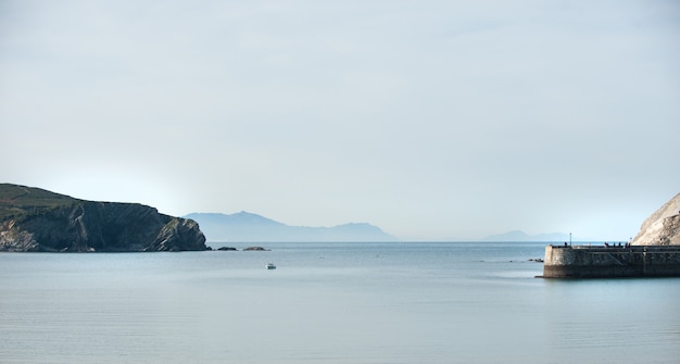 Calm sea, boat on the coast