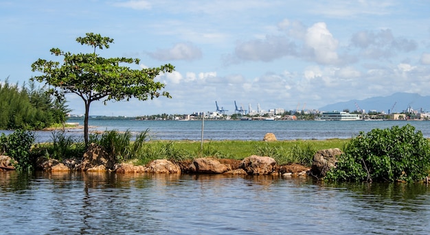 Calm sea with a natural breakwater and harbour in the background in Puerto Rico