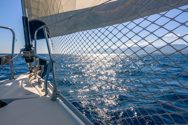 Calm sea. The yacht staysail makes a shadow from the bright sun