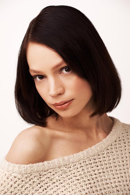 Calm and serene Darkhaired young woman against a white background