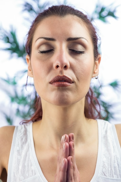 Photo calm woman with eyes closed and hands joined