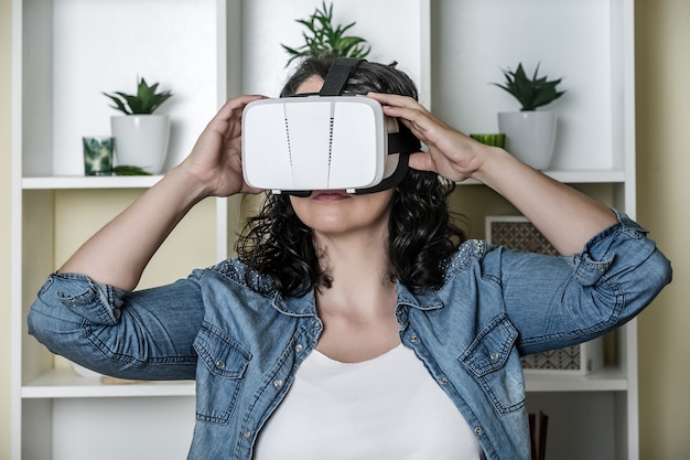 Calm young woman in virtual reality glasses