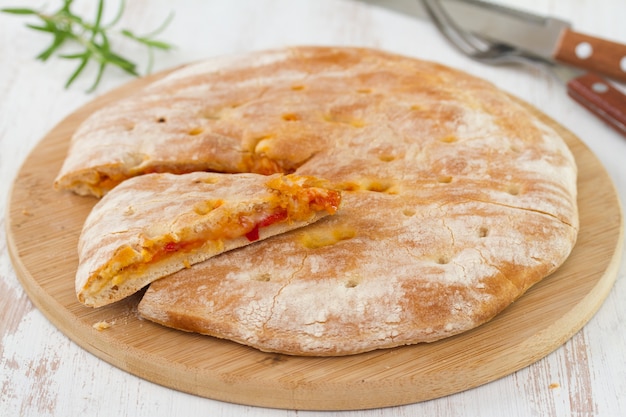 Calzone in on brown wooden desk