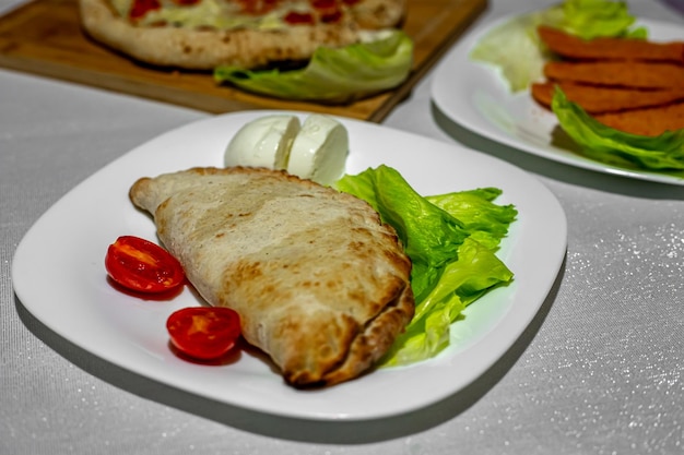 Calzone stuffed pizza homemade italian meat and cheese calzones with sauce mozzarella cheese and