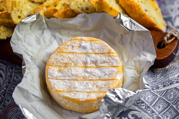 Photo camembert on board. cheese for advertising. for a large board. bree from the oven. cheese baked in