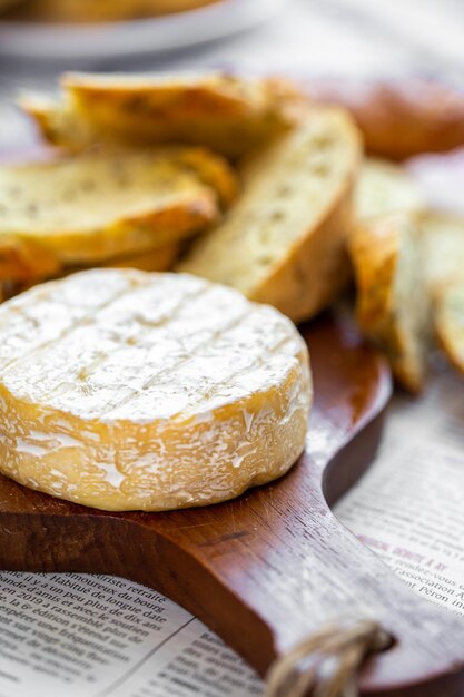 Camembert on board. Cheese for advertising. For a large board. Bree from the oven.Cheese baked