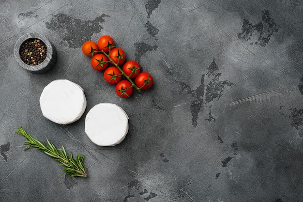 Camembert and brie cheese on gray stone table background top view flat lay with copy space for text