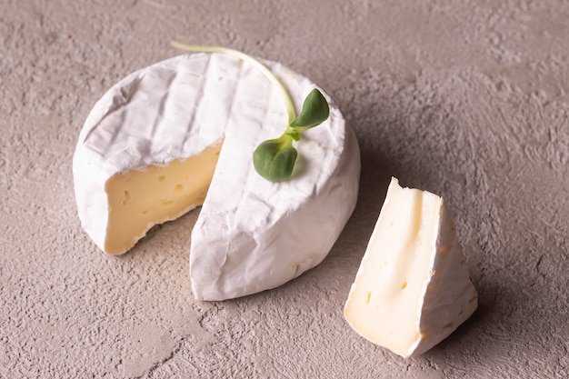 Camembert cheese on a beige background