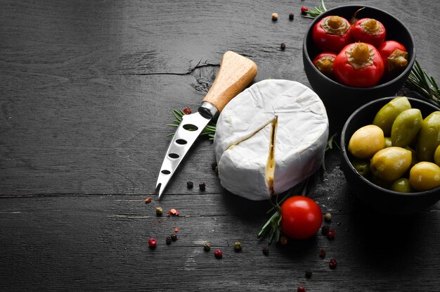 Camembert cheese on black background Top view Free space for your text