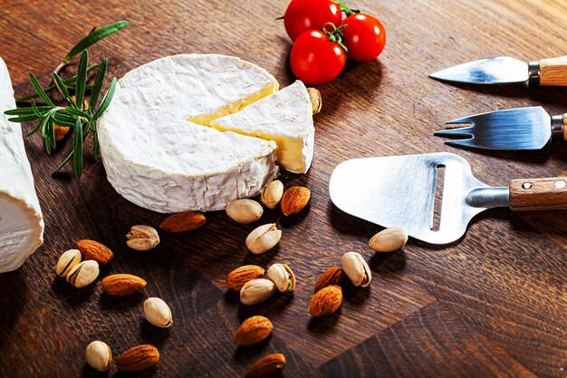 Camembert cheese or brie on wooden background.