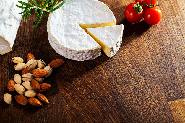 Camembert cheese or brie on wooden background