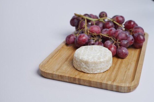 Camembert cheese and grape fruit on table