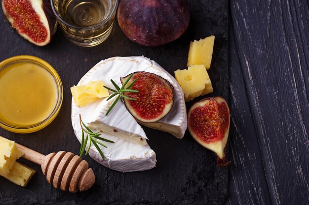 Camembert cheese with  figs, honey and wine. Selective focus.