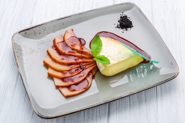 Camembert cheese with pear in wine sauce