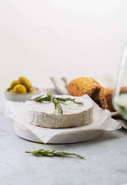 Camembert cheese with rosemary and olives