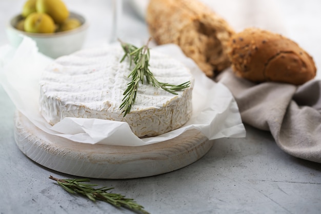 Camembert cheese with rosemary and olives