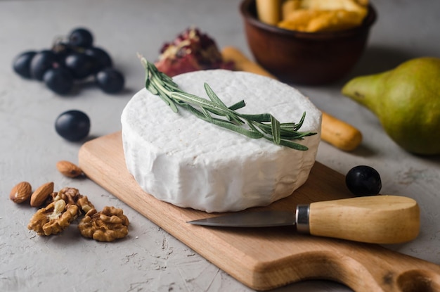 Camembert cheese with white mold walnuts and honey