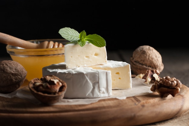 Camembert  cheese on wooden background.