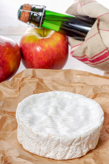 Camembert of Normandy with apples and bottle of cider