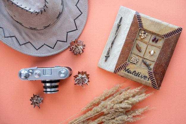 Camera on background with travel hat vacation concept flat lay view