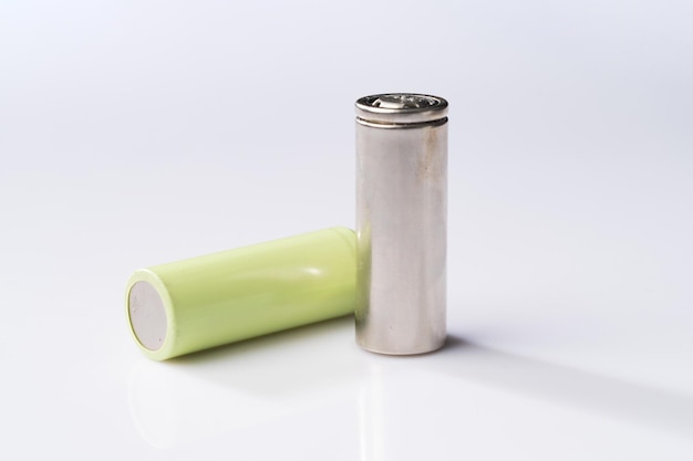 Camera battery and lithium battery on simple background